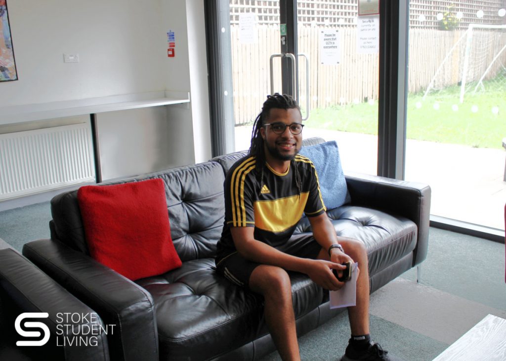 Winner of Stoke Student Living 'Years Free Rent competition' relaxing in the Poulson communal space.