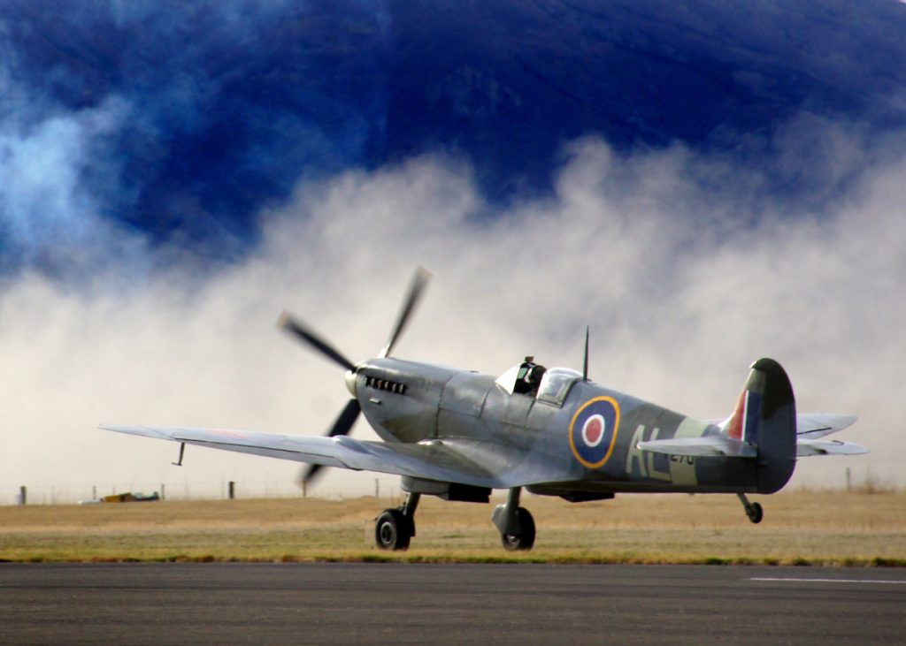 A spitfire plane in on a runway getting ready for take off